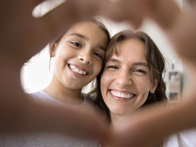 Cheerful,Daughter,Kid,And,Young,Mom,Looking,At,Camera,Through